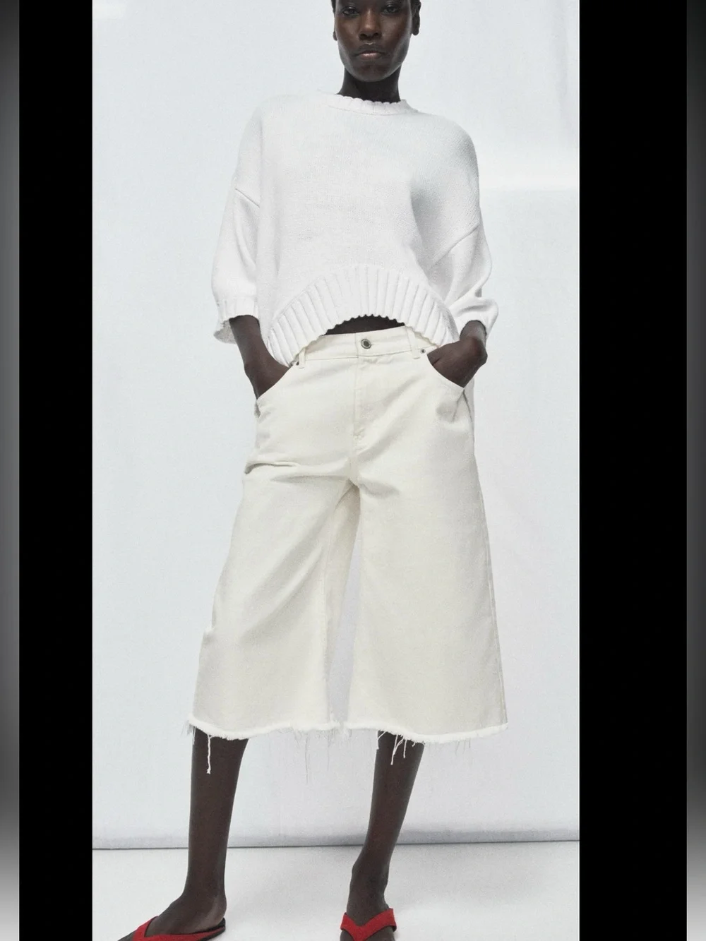 ZARA Loose-fit round neck short sleeve jumper with asymmetric hem.